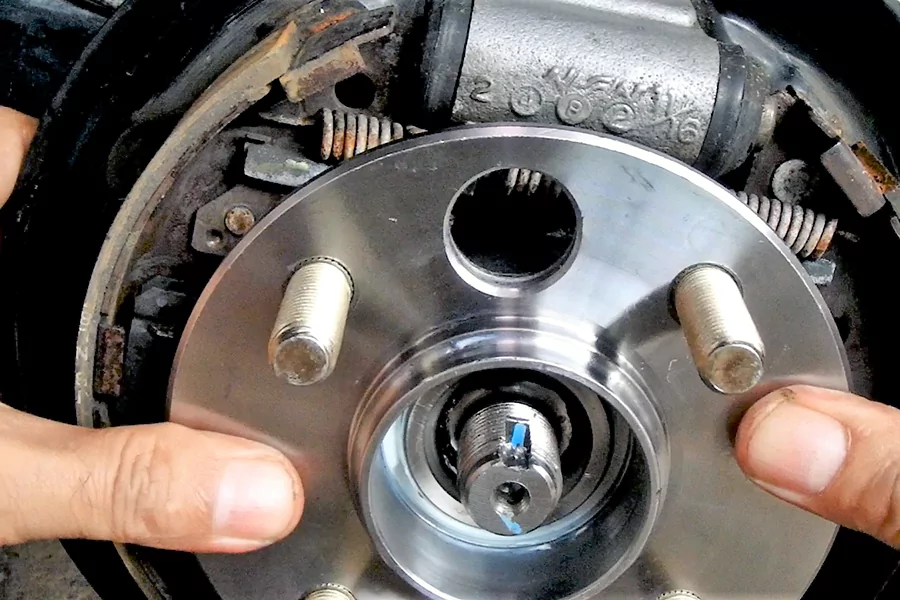 The picture shows workers maintaining the wheel hub assembly