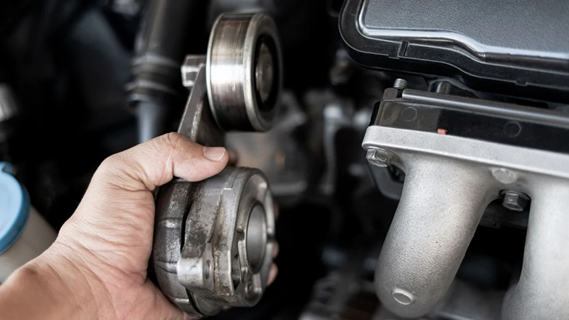 Replacing a serpentine belt tensioner pulley during engine maintenance